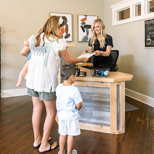 Chiropractic-Belton-TX-Parent-With-Child-Checking-In.jpg